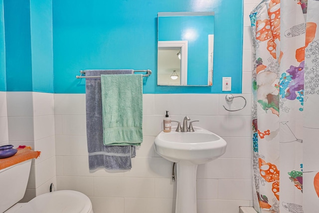 351 Bch 87th St, Rockaway Beach, NY 11693 - bathroom with tile walls, a shower with curtain, and wainscoting