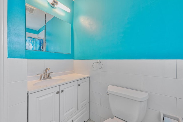 351 Bch 87th St, Rockaway Beach, NY 11693 - full bathroom featuring tile walls, vanity, a wainscoted wall, and curtained shower