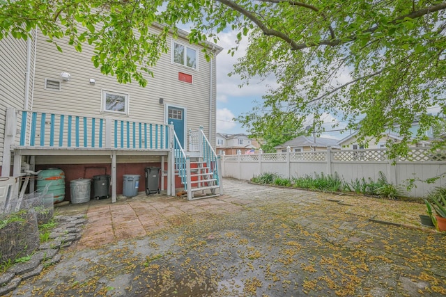 351 Bch 87th St, Rockaway Beach, NY 11693 - back of property featuring stairway, a deck, and a patio