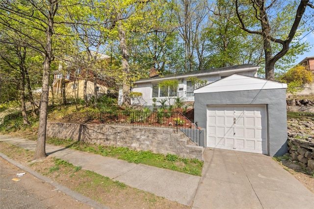 single story home with a chimney, stucco siding, and driveway