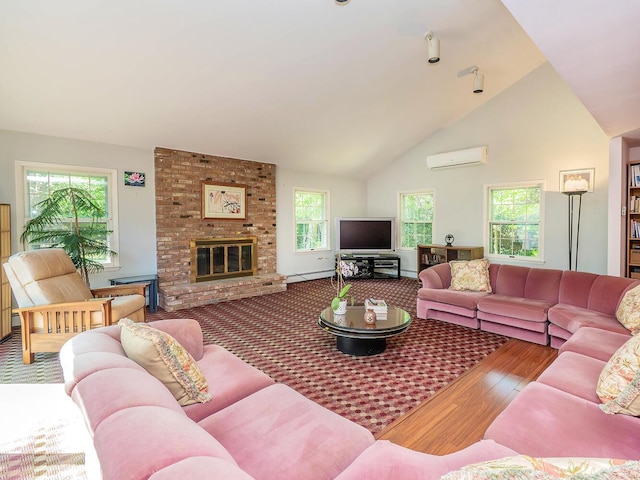 living room featuring a brick fireplace, a wall mounted air conditioner, plenty of natural light, and wood finished floors