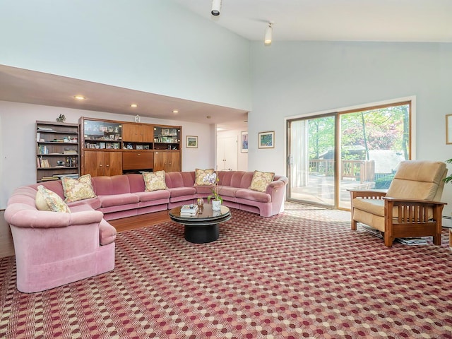 carpeted living room with recessed lighting and high vaulted ceiling