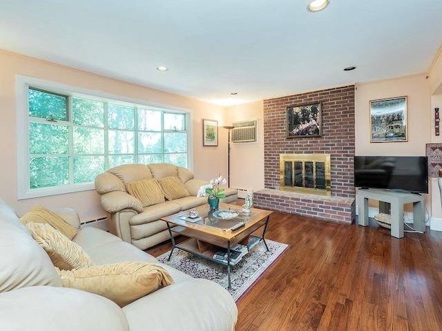 living area featuring wood finished floors, a wall mounted air conditioner, a brick fireplace, a baseboard radiator, and recessed lighting