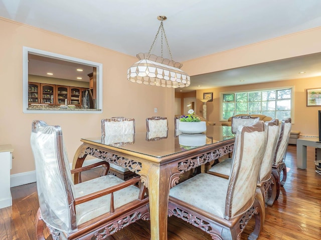 dining space featuring recessed lighting, baseboards, and wood finished floors