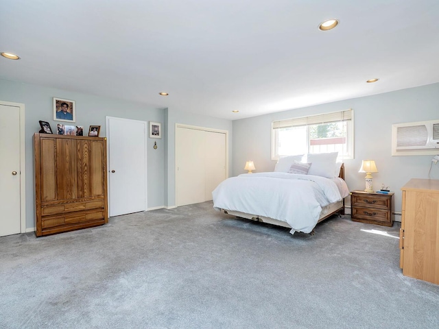 bedroom with a wall mounted air conditioner, recessed lighting, and carpet