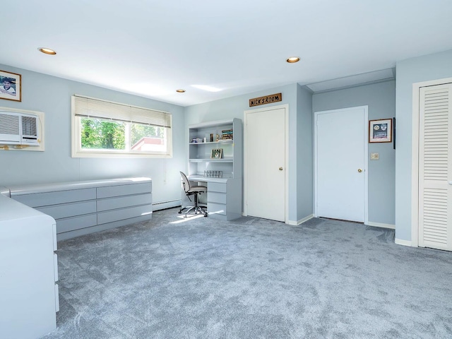 unfurnished office featuring a baseboard radiator, recessed lighting, carpet, and an AC wall unit