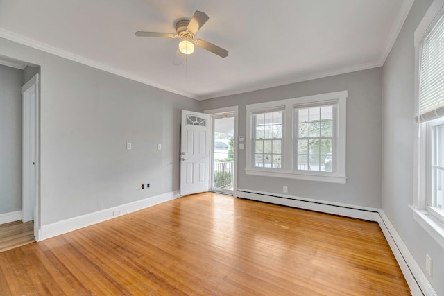 spare room with baseboards, wood finished floors, ceiling fan, and a baseboard heating unit