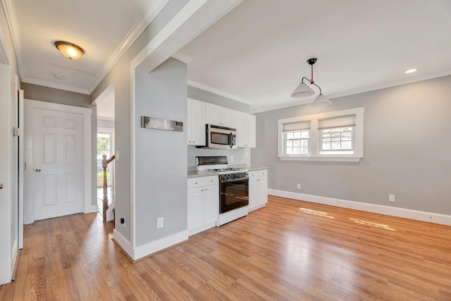kitchen with stainless steel microwave, gas range, white cabinets, baseboards, and light wood-type flooring