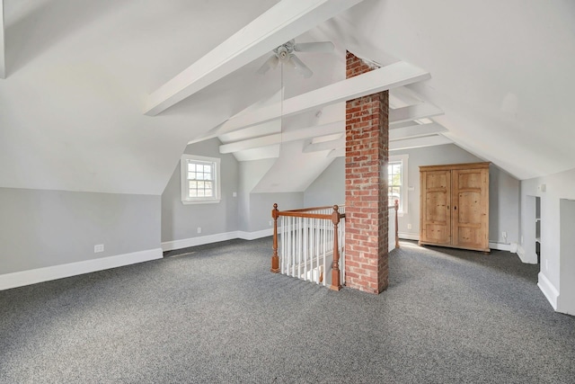 bonus room featuring vaulted ceiling with beams, a baseboard heating unit, carpet, ceiling fan, and baseboards
