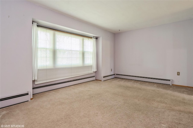 carpeted empty room featuring a baseboard heating unit