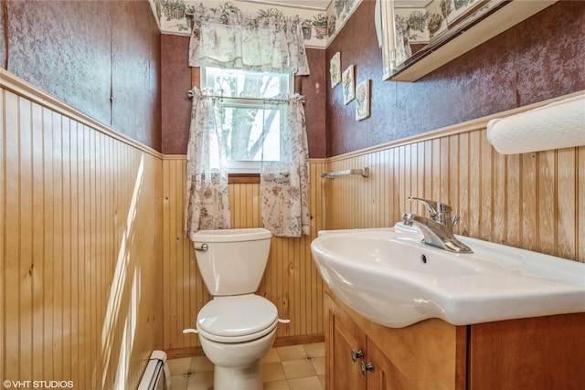 bathroom with vanity, wallpapered walls, wainscoting, and toilet