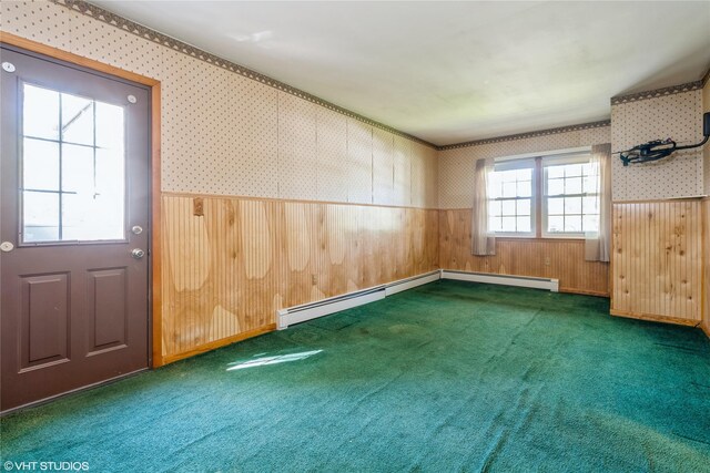 spare room featuring carpet flooring, wainscoting, and wallpapered walls