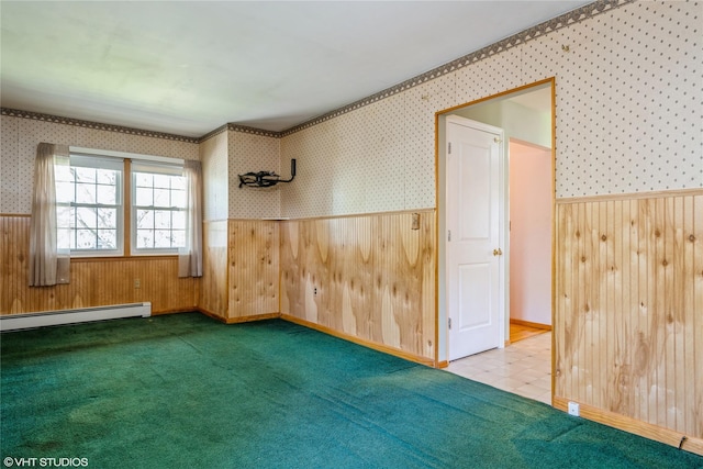 carpeted spare room with a wainscoted wall, a baseboard radiator, wood walls, and wallpapered walls