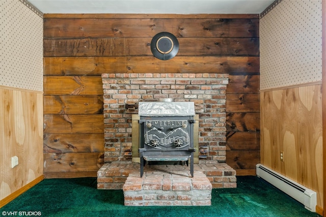 room details with a baseboard radiator, carpet, wooden walls, and a wood stove