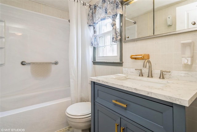 full bathroom with vanity, shower / tub combo, toilet, and tasteful backsplash