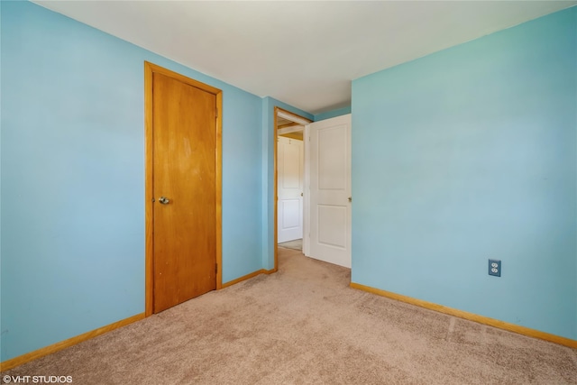 unfurnished bedroom featuring baseboards and carpet floors