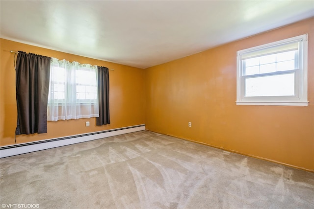 carpeted empty room with a wealth of natural light and a baseboard radiator