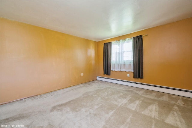 carpeted spare room with baseboard heating