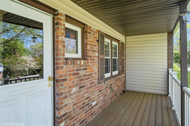 wooden terrace featuring covered porch