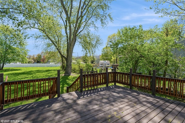 wooden deck featuring a fenced backyard and a yard