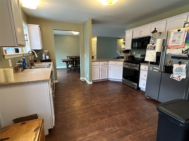 487 Southwoods Dr, Monticello, NY 12701 - kitchen with dark wood finished floors, white cabinetry, stainless steel appliances, and a sink