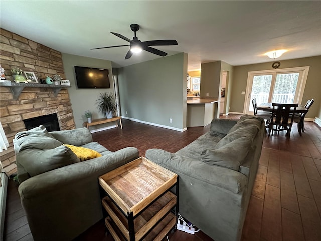 487 Southwoods Dr, Monticello, NY 12701 - living area featuring a ceiling fan, baseboards, a fireplace, and dark wood-style flooring
