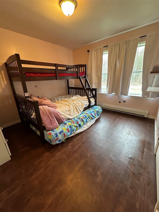 487 Southwoods Dr, Monticello, NY 12701 - bedroom featuring a baseboard heating unit, baseboards, multiple windows, and wood finished floors