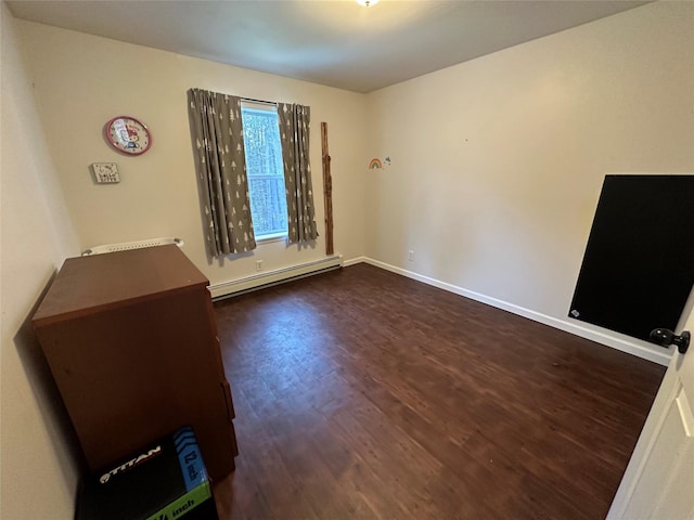 487 Southwoods Dr, Monticello, NY 12701 - spare room featuring baseboards, dark wood-type flooring, and a baseboard radiator