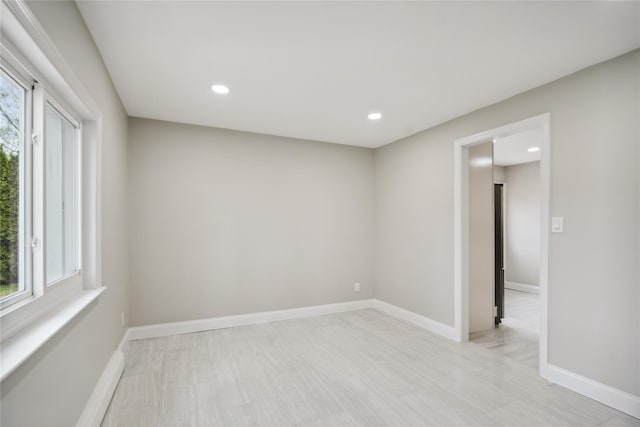 unfurnished room with baseboards and recessed lighting
