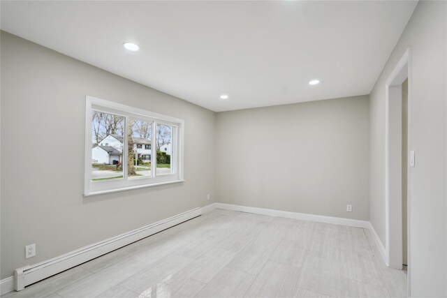 spare room with recessed lighting, baseboards, and a baseboard radiator