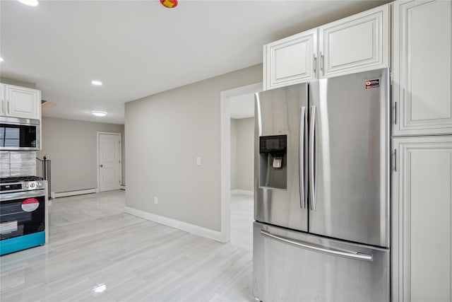 kitchen with baseboard heating, baseboards, white cabinets, stainless steel appliances, and recessed lighting