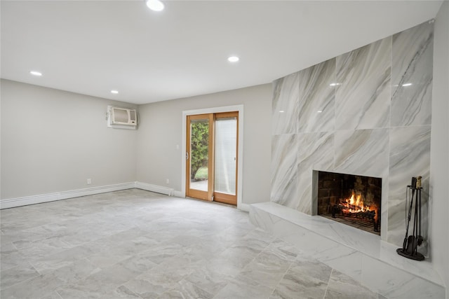 unfurnished living room featuring recessed lighting, a wall mounted AC, marble finish floor, and a fireplace