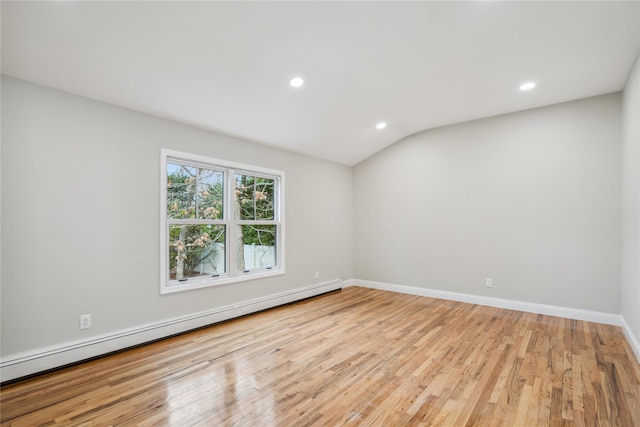spare room with baseboards, a baseboard radiator, light wood finished floors, lofted ceiling, and recessed lighting