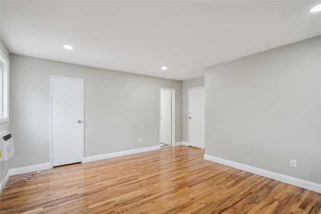 spare room with recessed lighting, baseboards, and light wood finished floors