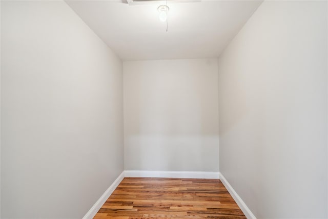 spare room with baseboards and light wood finished floors