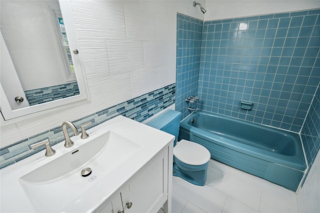 bathroom with vanity, toilet, tile walls, tasteful backsplash, and  shower combination