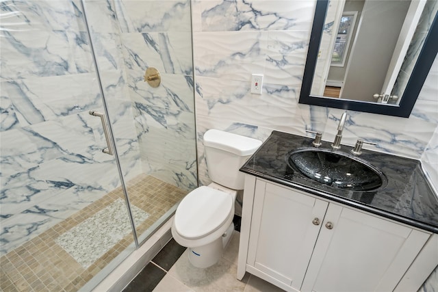 full bath featuring vanity, toilet, tile patterned floors, a marble finish shower, and tile walls