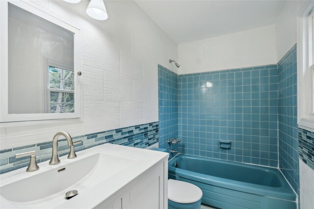 36 Pinewood Dr, Commack, NY 11725 - full bathroom featuring tile walls, shower / bathtub combination, toilet, vanity, and backsplash