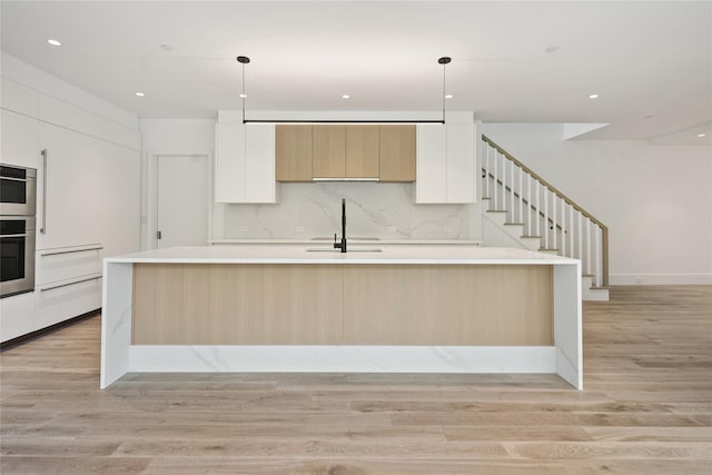 41 Richmondville Ave Unit Duplex 2, Call Listing Agent, CT 06880 - kitchen with modern cabinets, light wood-style floors, a sink, white cabinetry, and recessed lighting