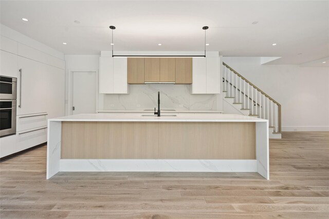 41 Richmondville Ave Unit Duplex 2, Call Listing Agent, CT 06880 - kitchen with modern cabinets, light wood-style floors, a sink, white cabinetry, and recessed lighting