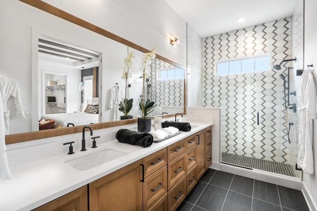full bathroom featuring a shower stall, tile patterned flooring, double vanity, and a sink