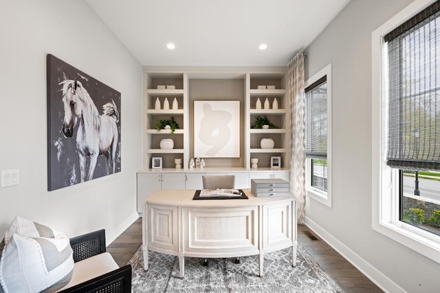 home office featuring recessed lighting, built in features, baseboards, visible vents, and dark wood-type flooring