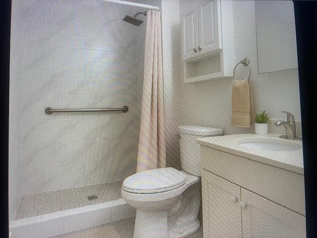 841 Prescott Pl, West Babylon, NY 11704 - bathroom with toilet, vanity, tiled shower, and tile walls