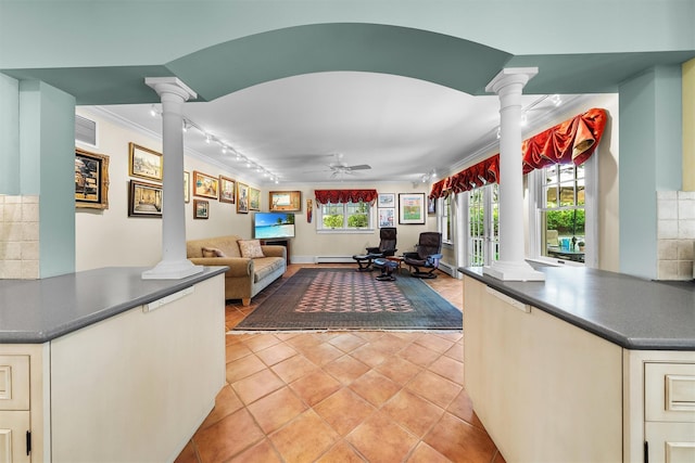 living area featuring a ceiling fan, decorative columns, visible vents, light tile patterned floors, and ornamental molding