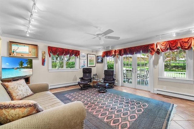living room with track lighting, baseboard heating, tile patterned floors, and a wealth of natural light