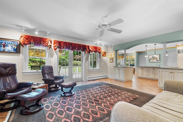 living area featuring ceiling fan, crown molding, light tile patterned floors, track lighting, and a baseboard heating unit