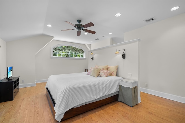 bedroom with ceiling fan, visible vents, vaulted ceiling, recessed lighting, and light wood-style flooring