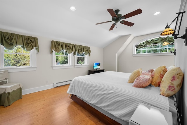 bedroom with recessed lighting, multiple windows, and baseboard heating