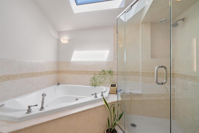 full bath with a skylight, a shower stall, and a garden tub