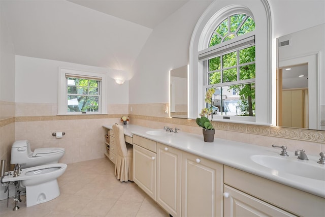 full bathroom with a sink, tile patterned floors, tile walls, visible vents, and a bidet
